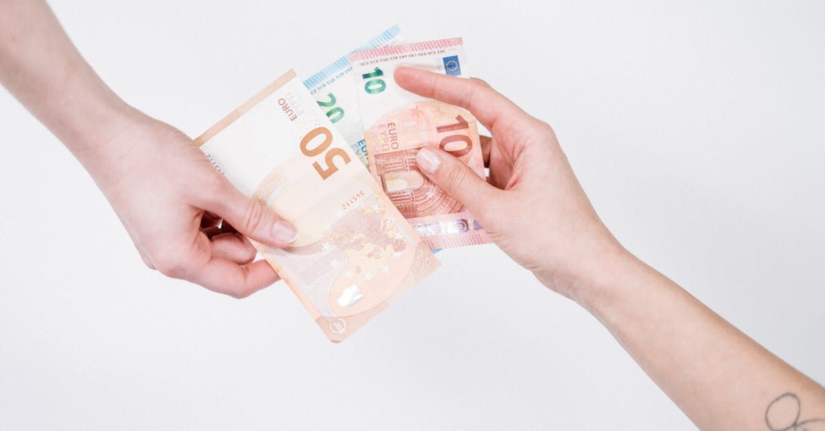 A person is handing another person a bunch of money.