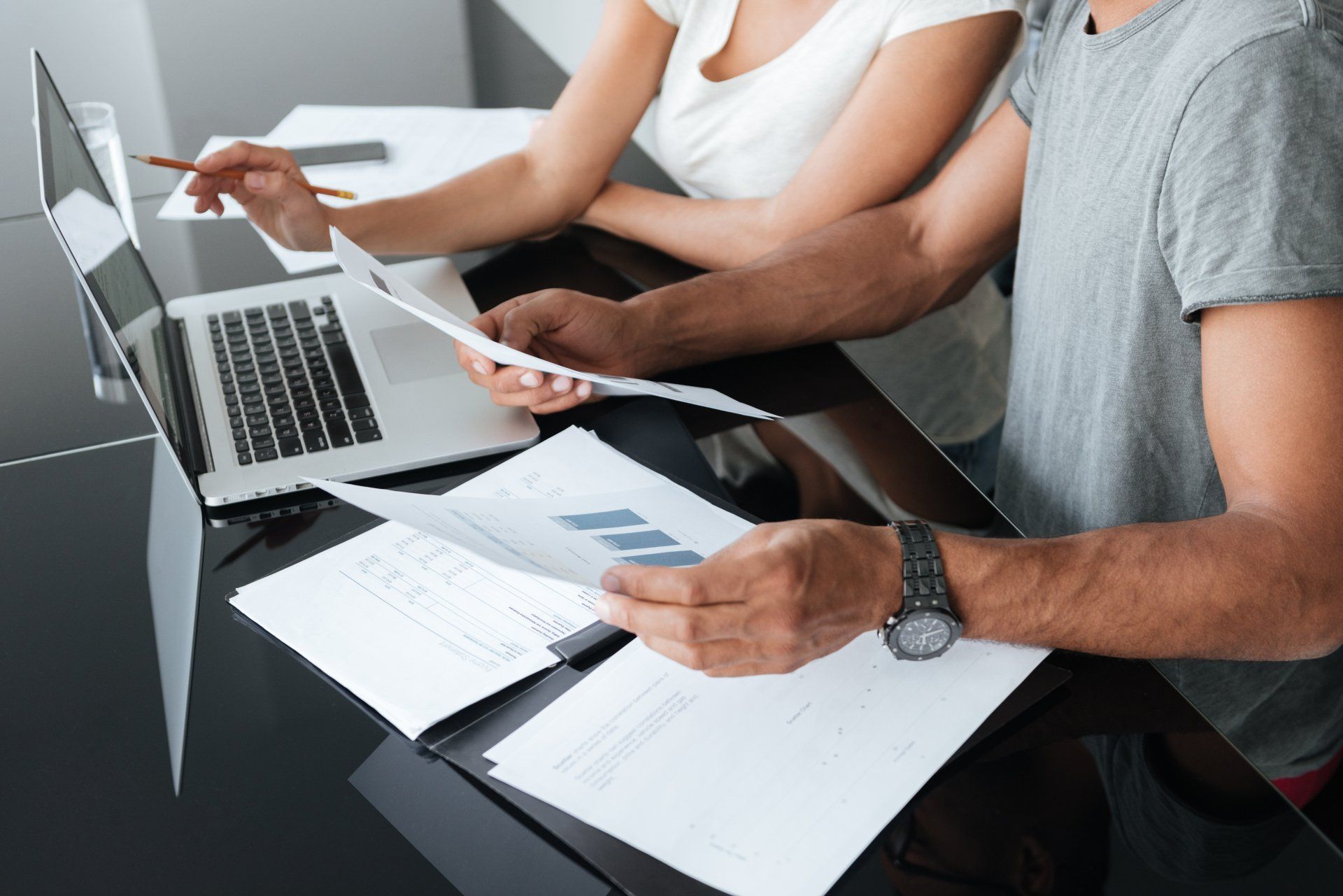 couple using laptop and analyzing their finances