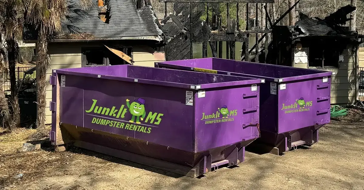 Two purple roll off dumpsters from Junk-It MS for dumpster rental in Jackson MS