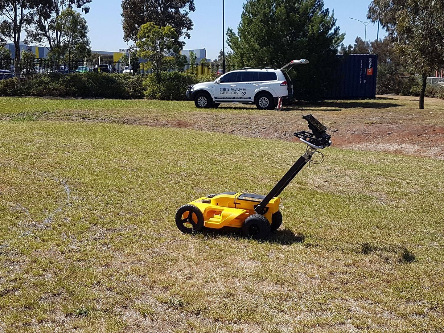 A yellow GPR  on grass.