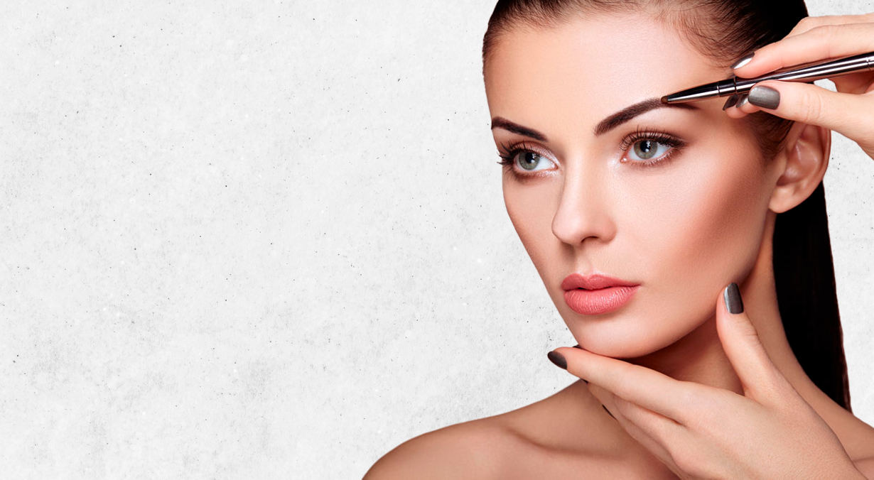 Woman having her eyebrow plucked with tweezers.