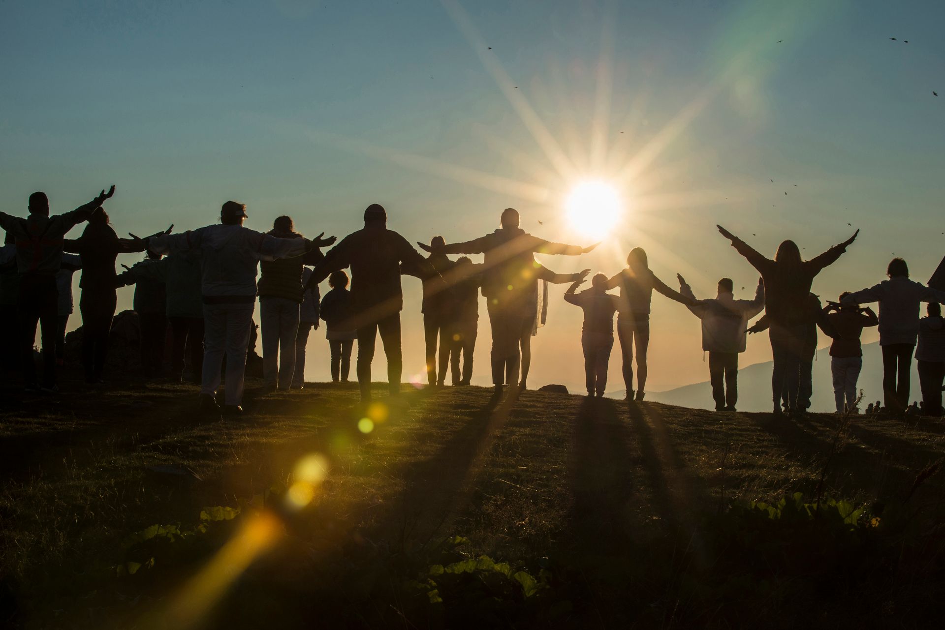 People on a mountaintop in the sunrise