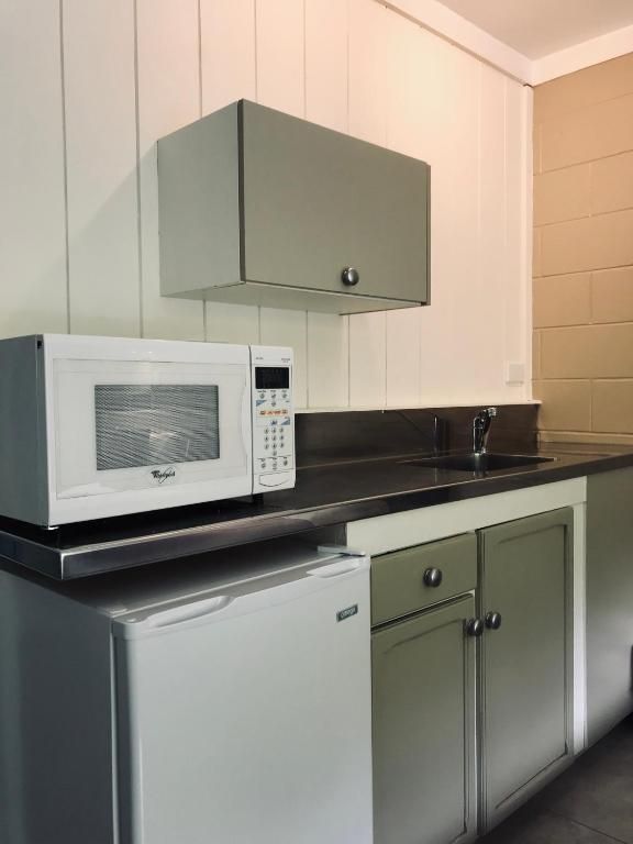 A kitchen with a microwave and a refrigerator