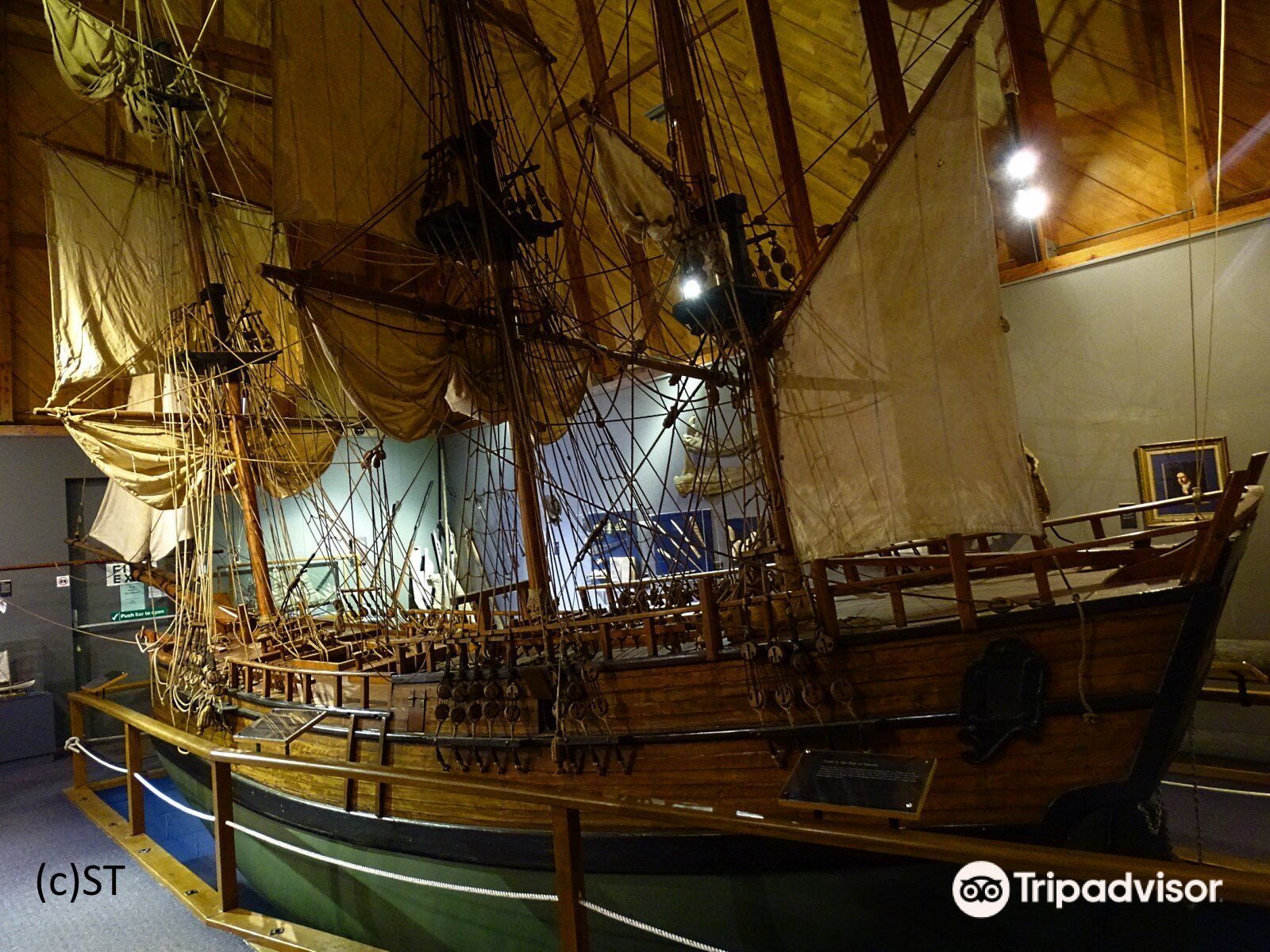 A model of a sailboat is on display in a museum.