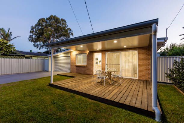 A small house with a wooden deck in front of it.