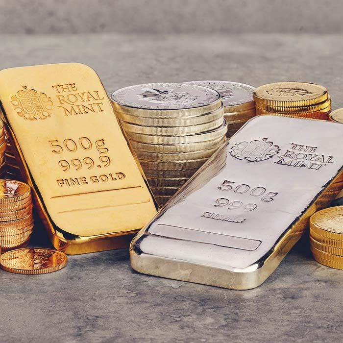 Gold and silver bars and coins, Royal Mint. Gold bar reads