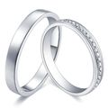 Two silver wedding rings, one plain, the other with small diamonds set in the band.