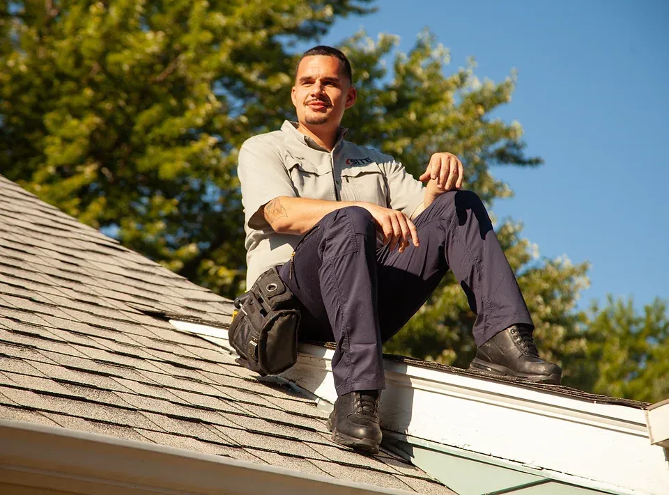 Commercial inspector Rick Francis sitting on top of roof
