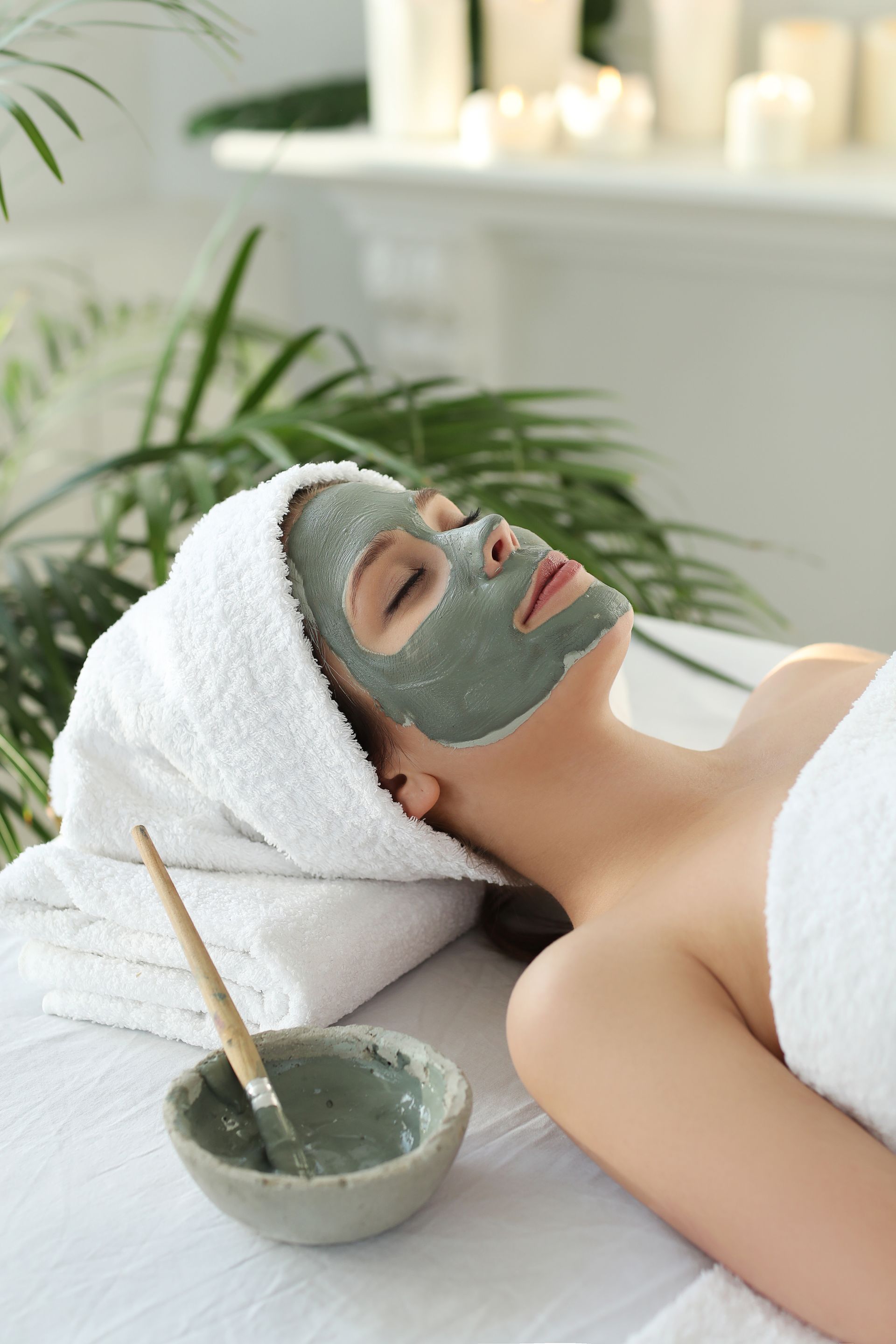 a woman with a mask on her face is laying on a table