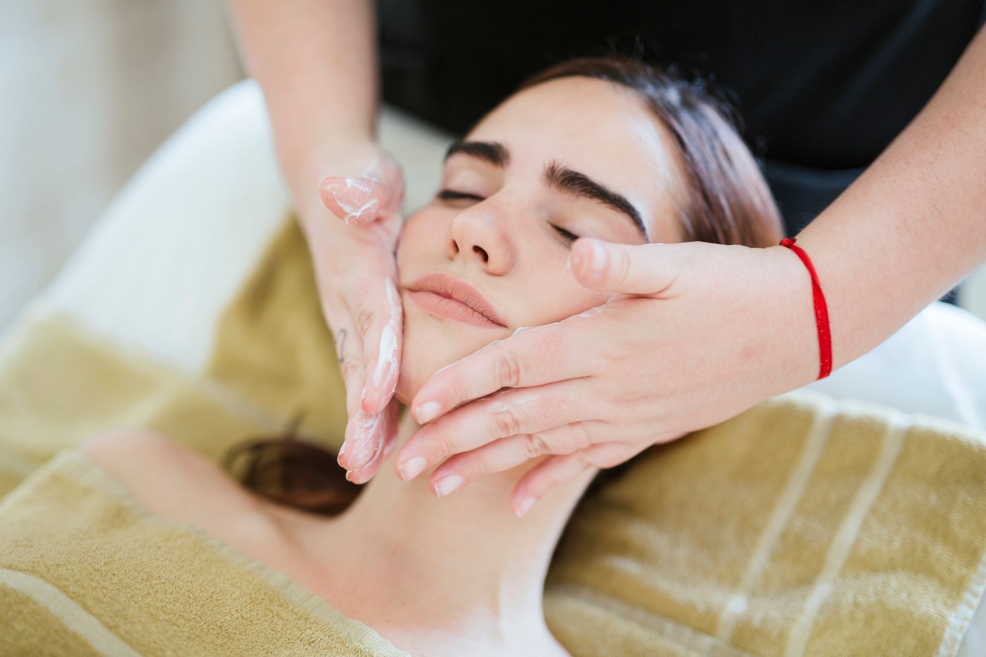 young woman receiving facial beauty treatment