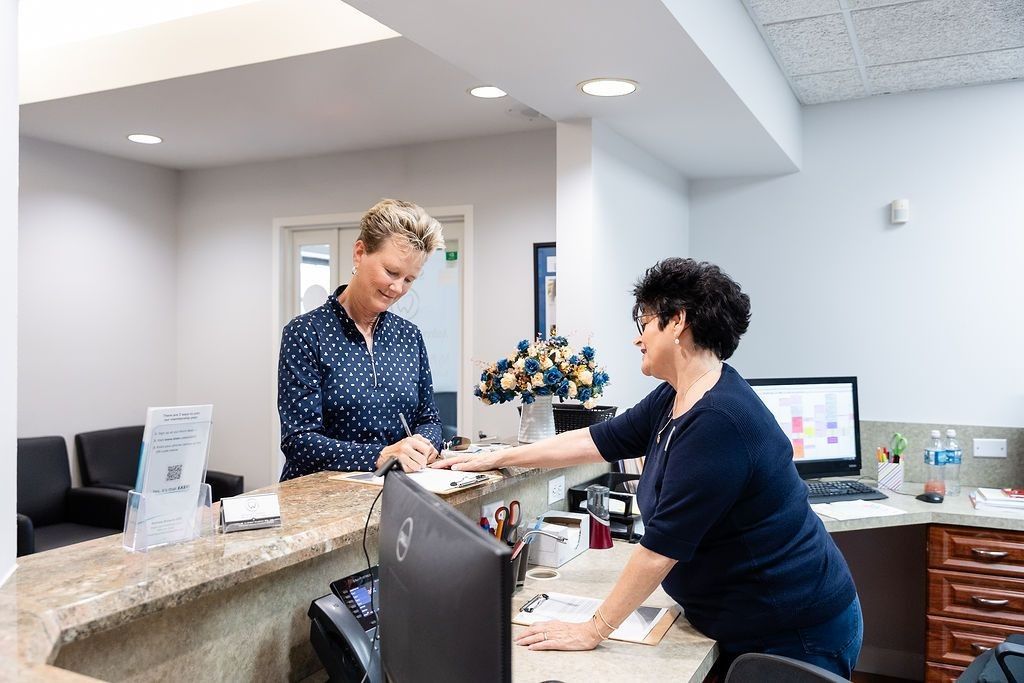 Front desk team helping a patient at My Pompano Dentist