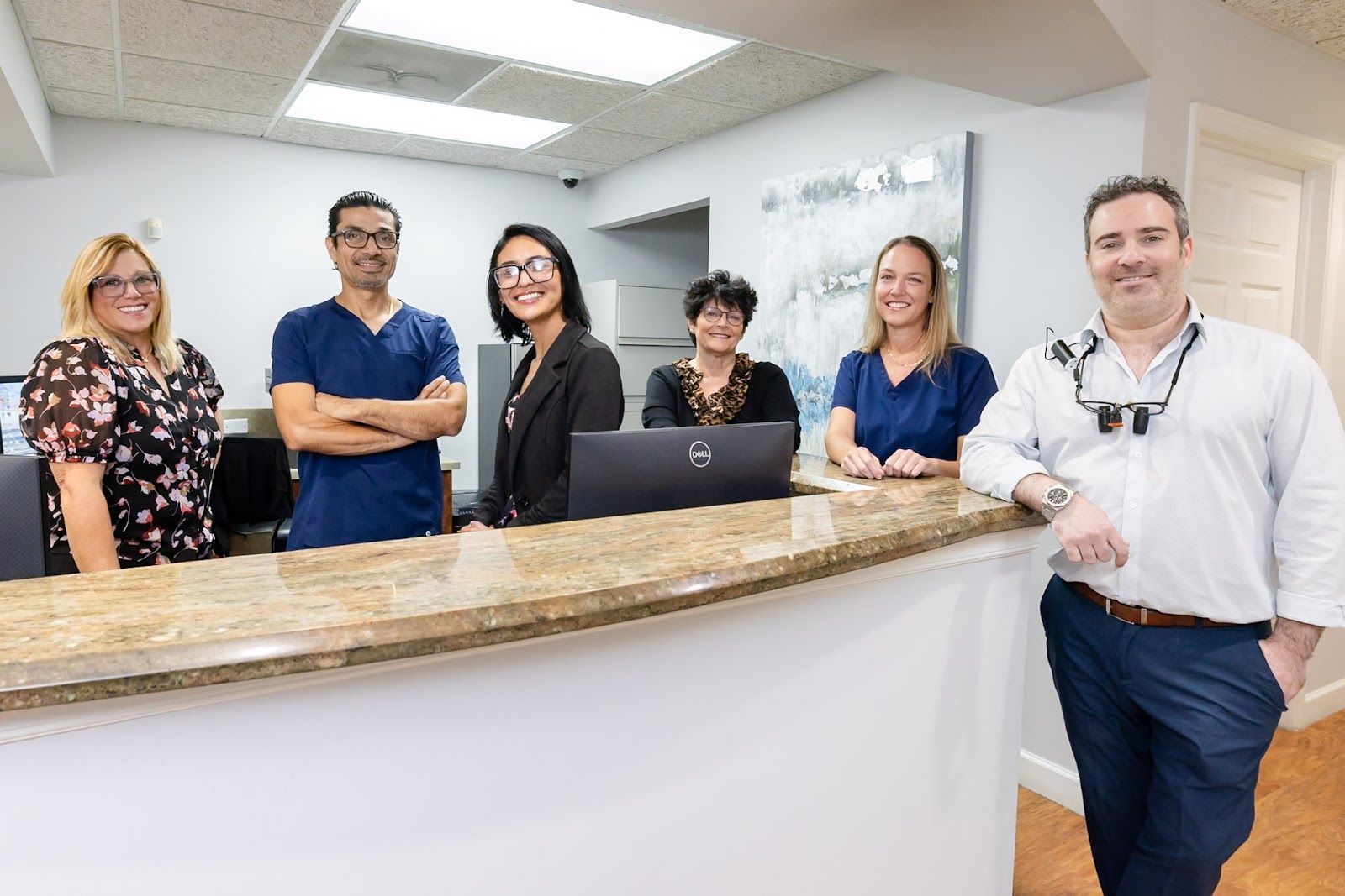 Dr. Andrew Browne and the My Pompano Dentist team at the front desk