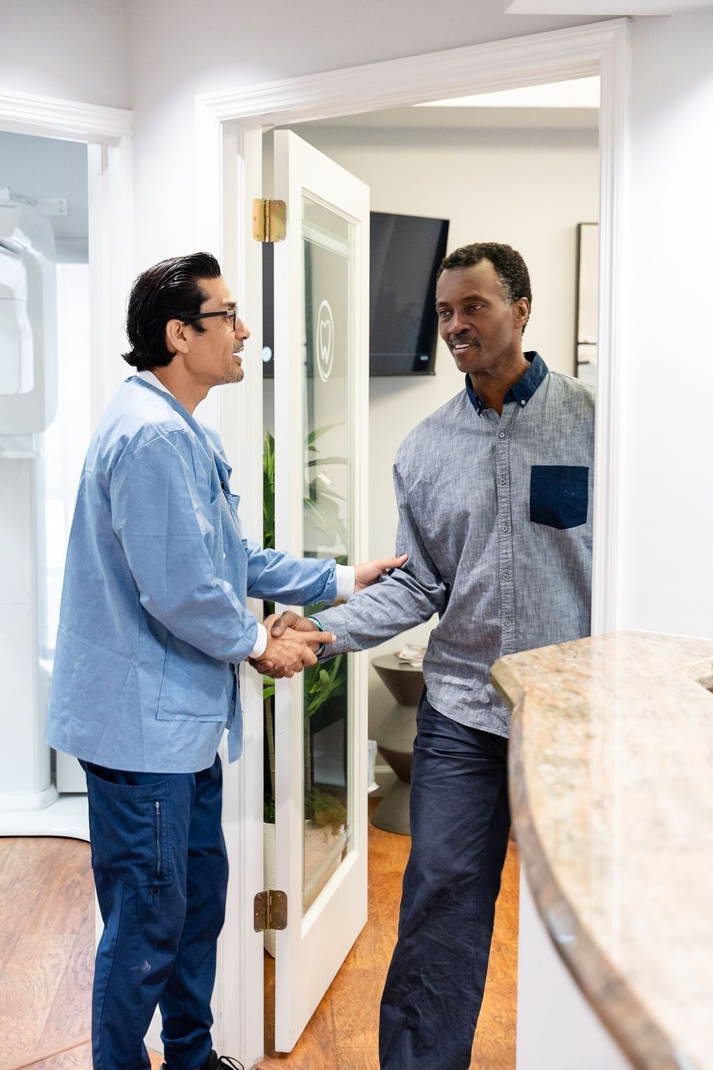 Welcoming a new patient with a handshake at My Pompano Dentist