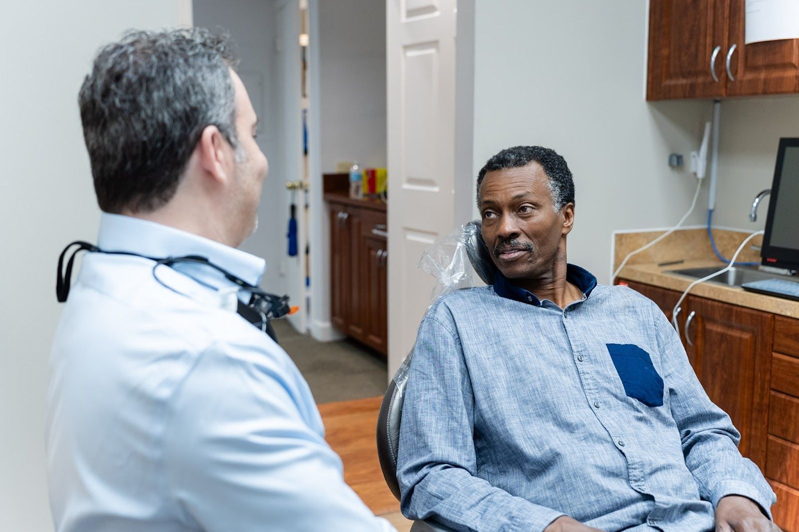 Dr. Andrew Browne talking with a patient about tooth pain in Pompano Beach