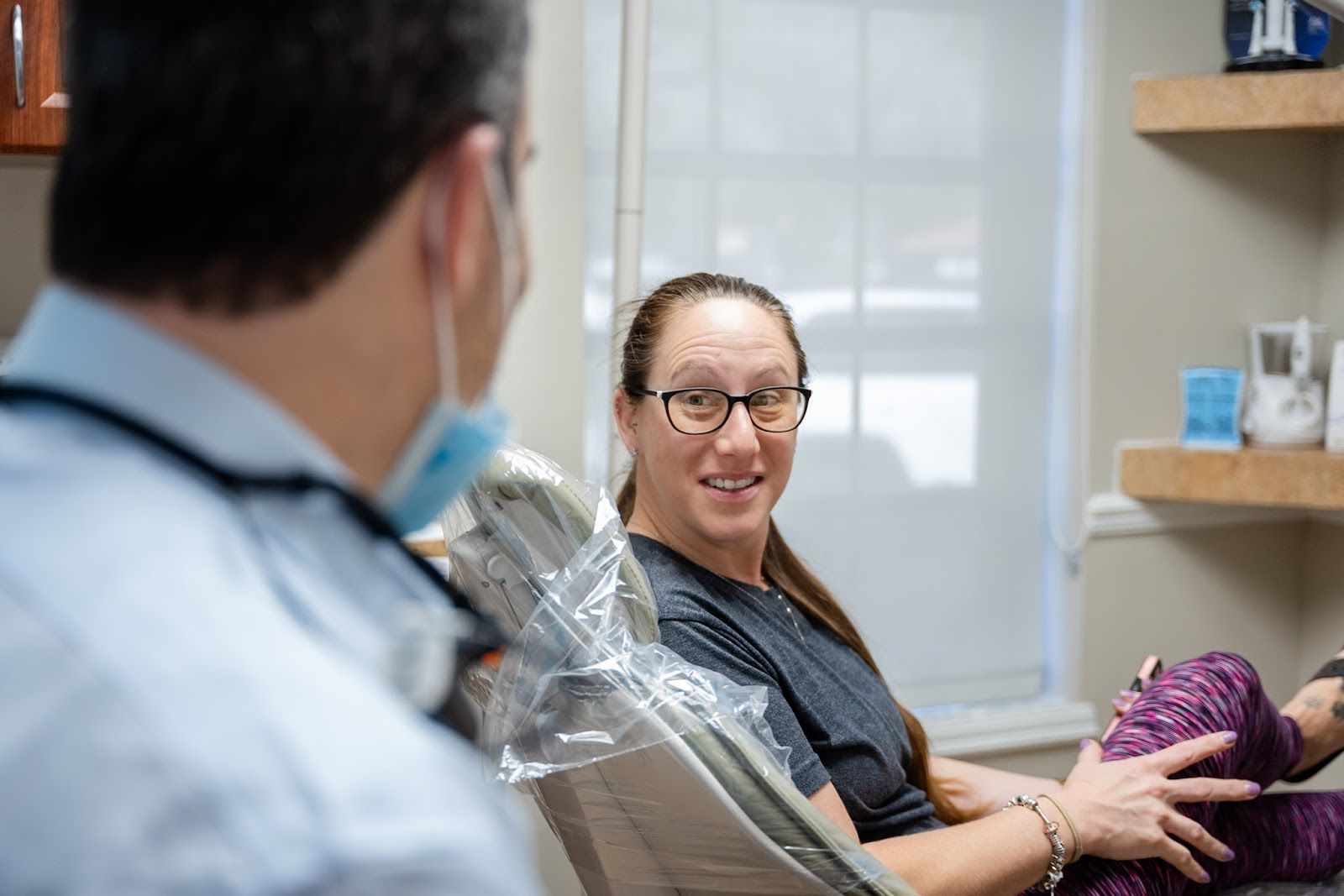 Patient laughing with Dr. Andrew Browne during a relaxed visit