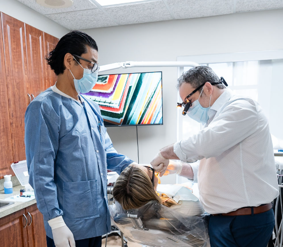 Dentist and assistant treating a patient in a bright clinic