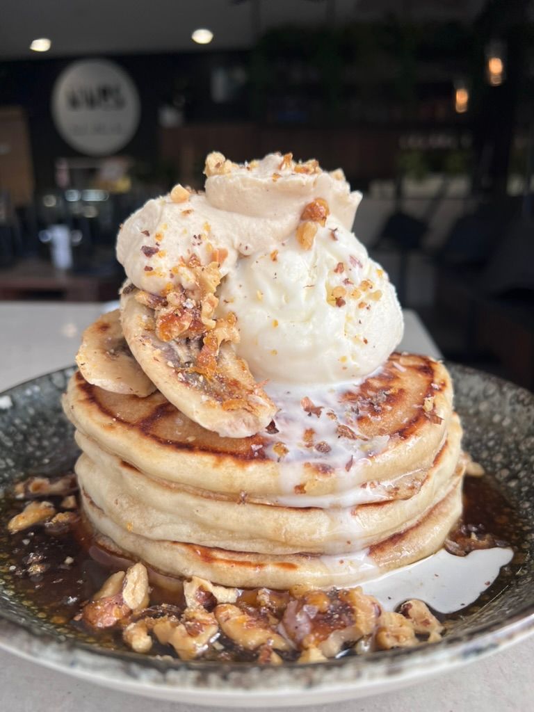 A stack of pancakes with ice cream as part of the all day menu items