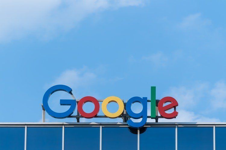 Google logo on a building against a blue sky
