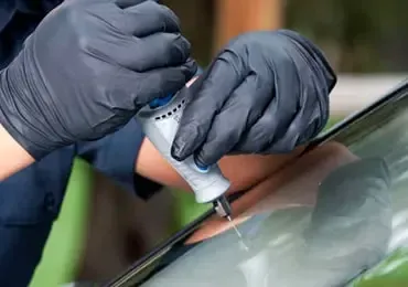 man-repairing-windshield man-repairing-windshield