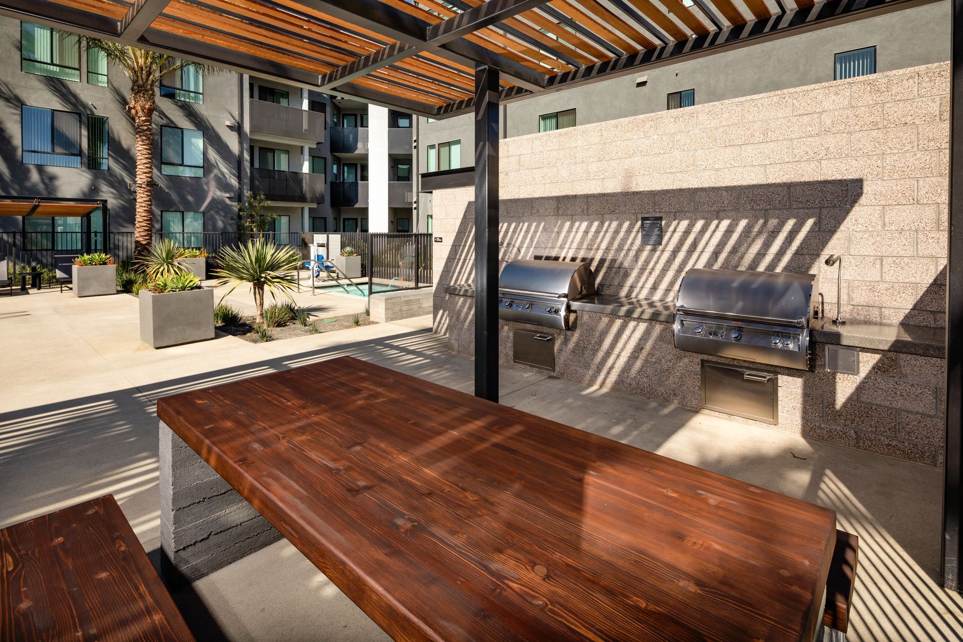 Exterior photo of grill area and picnic tables