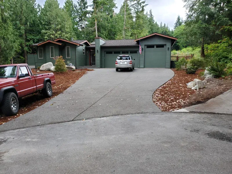 A red truck is parked in front of a house