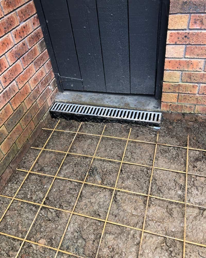 A Drain Is Sitting On The Ground Next To A Brick Wall β ARK Plumbing & Gasfitting In Moss Vale, NSW