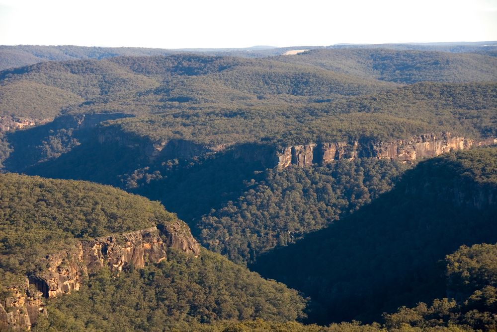 A View Of A Valley Surrounded By Mountains And Trees — ARK Plumbing & Gasfitting In Bundanoon, NSW