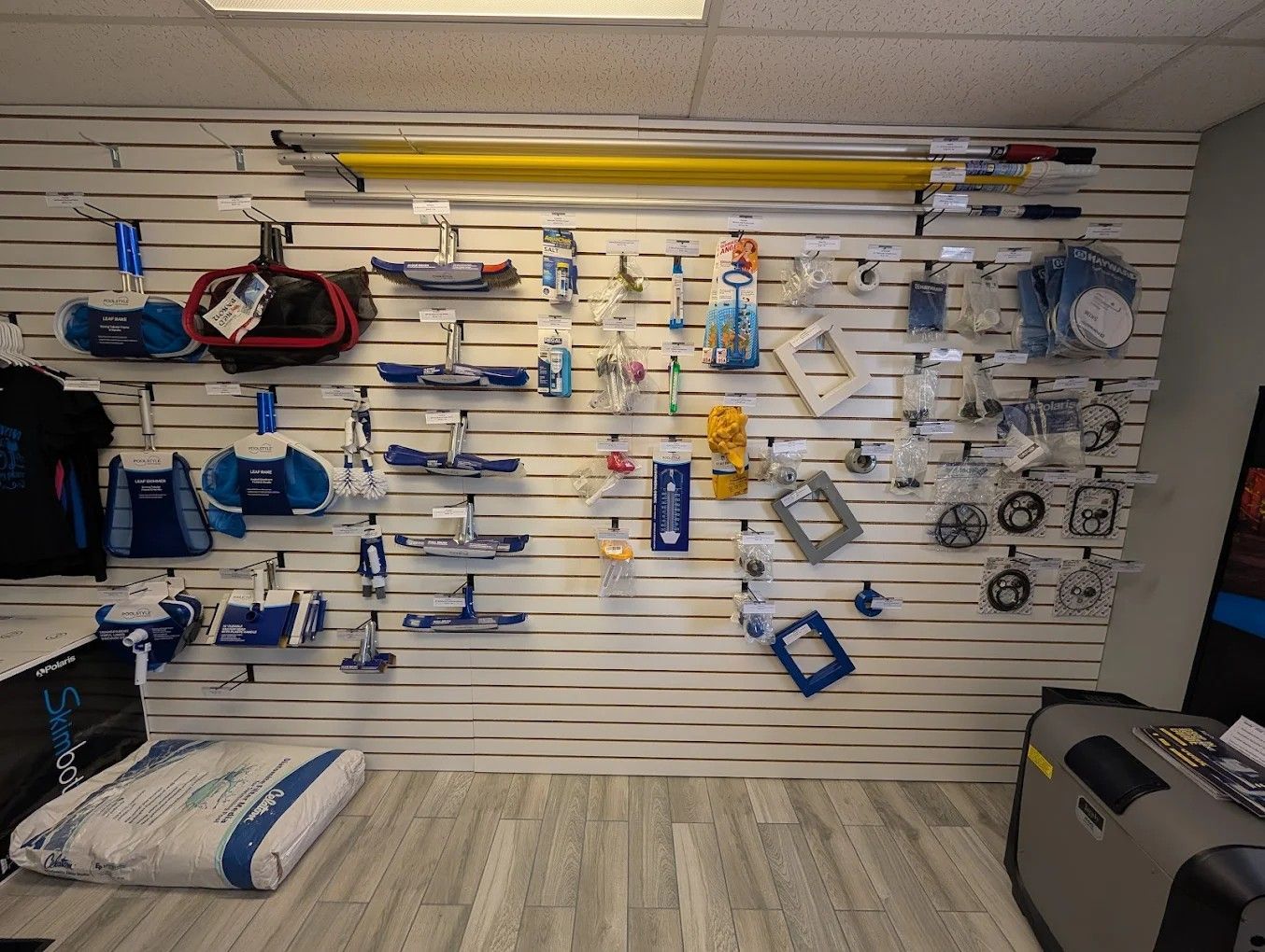 Slatwall display of blue and white fishing gear and accessories in a store aisle