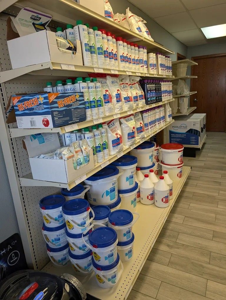 Shelves stocked with assorted bottled beverages and canned goods in a convenience store aisle