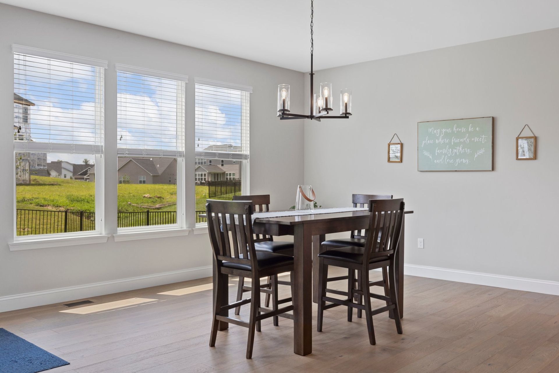 A dining room with a table and chairs and a chandelier.