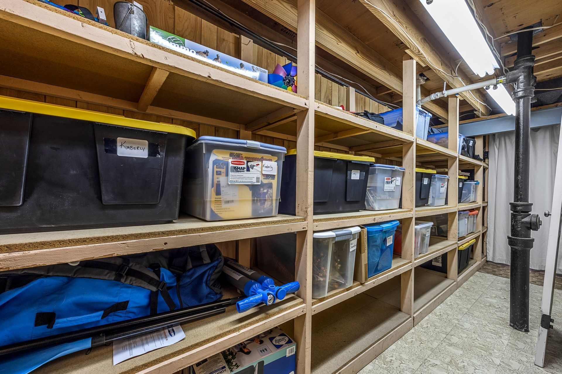 A storage room filled with lots of shelves and bins.