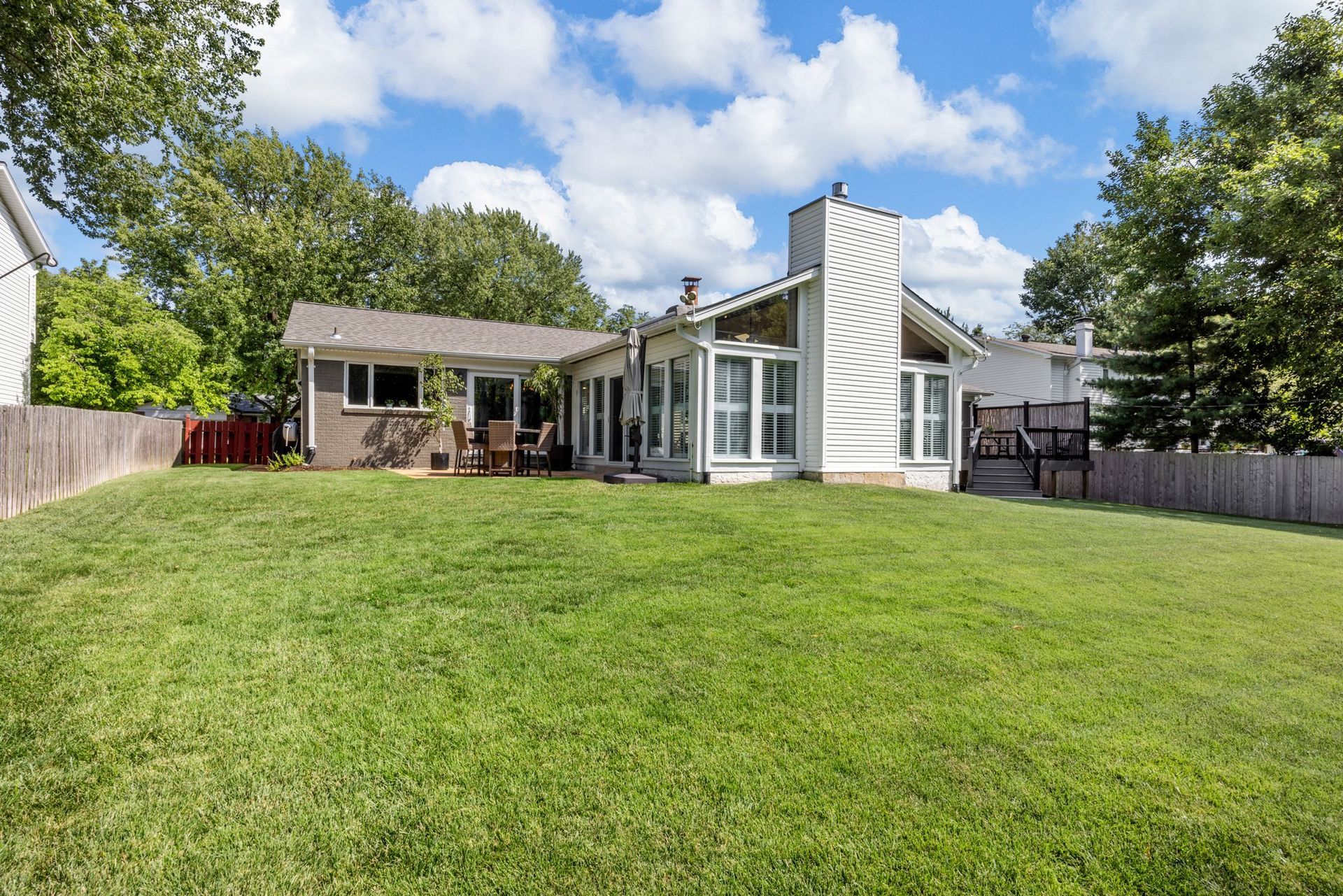 A house with a large lawn in front of it