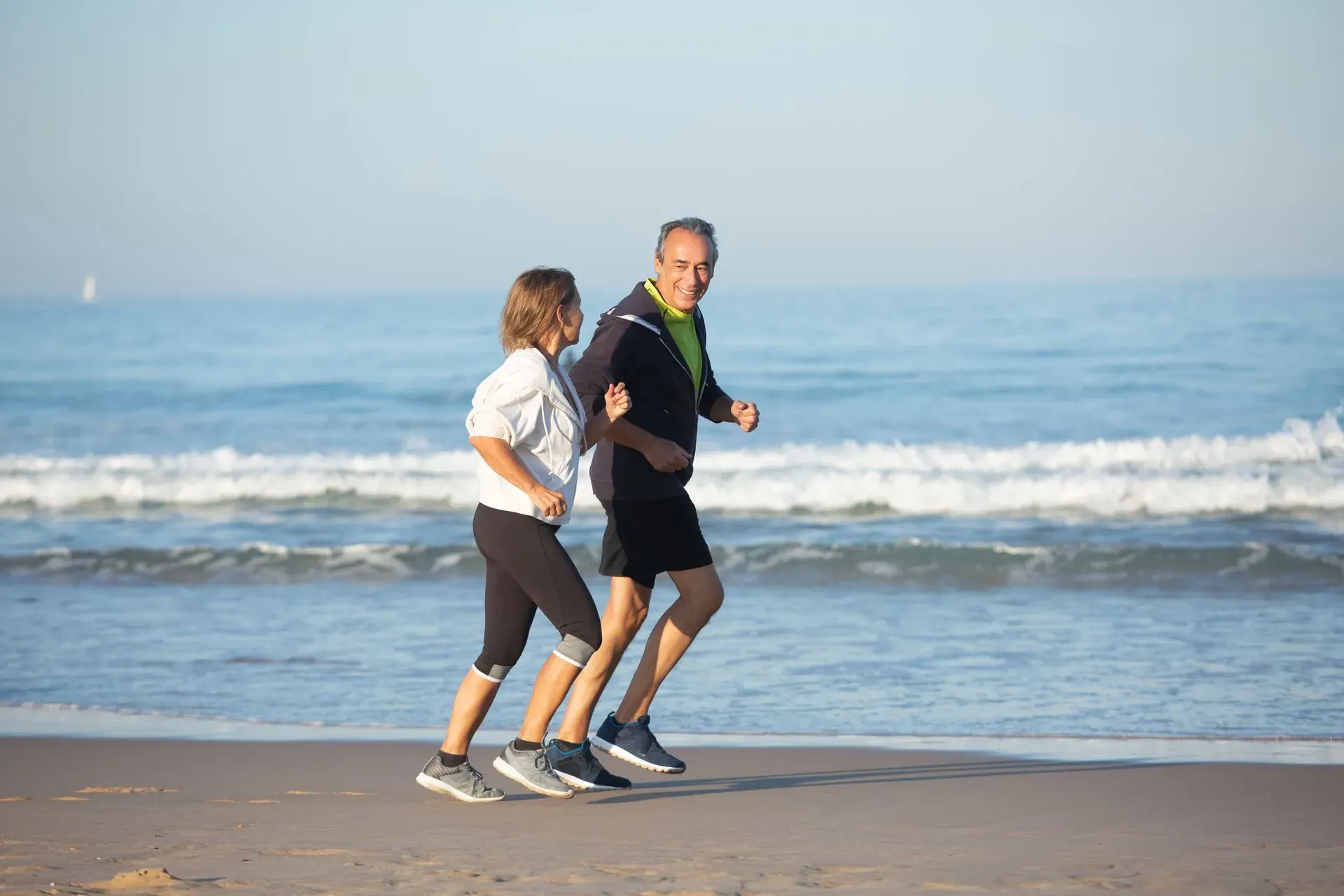 couple jogging on the beach