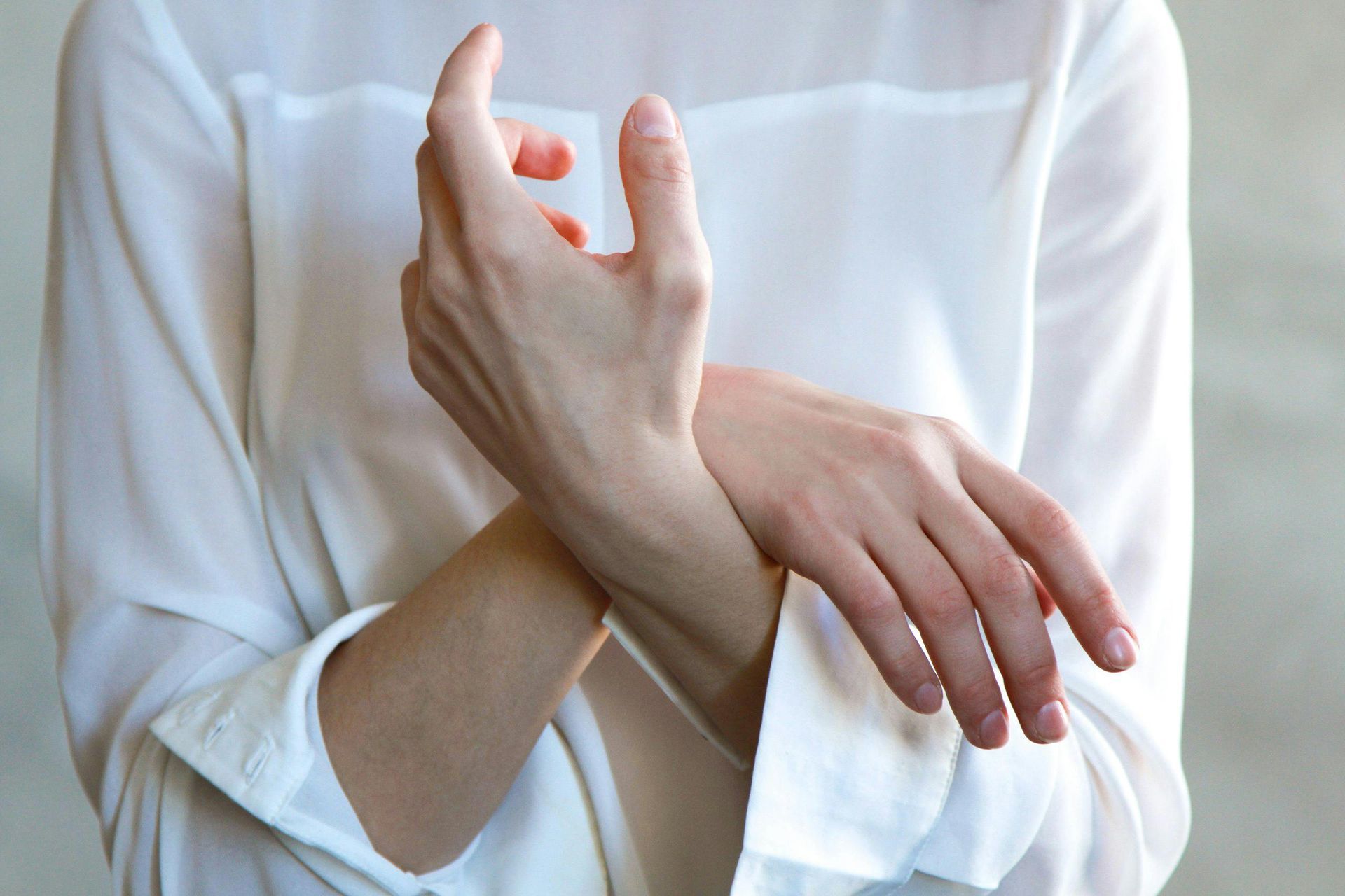 Woman Massaging Injured Hand
