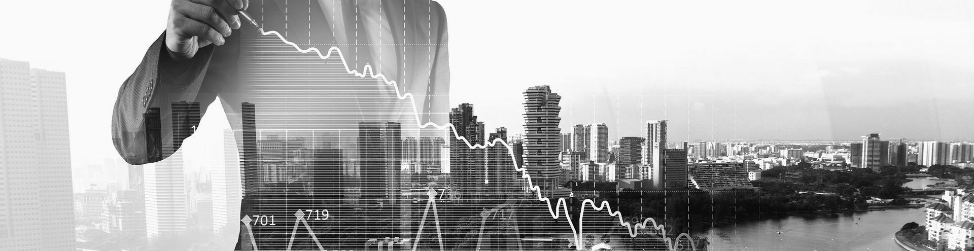 A business professional gestures toward a line graph showing a downward trend, superimposed over a city skyline.