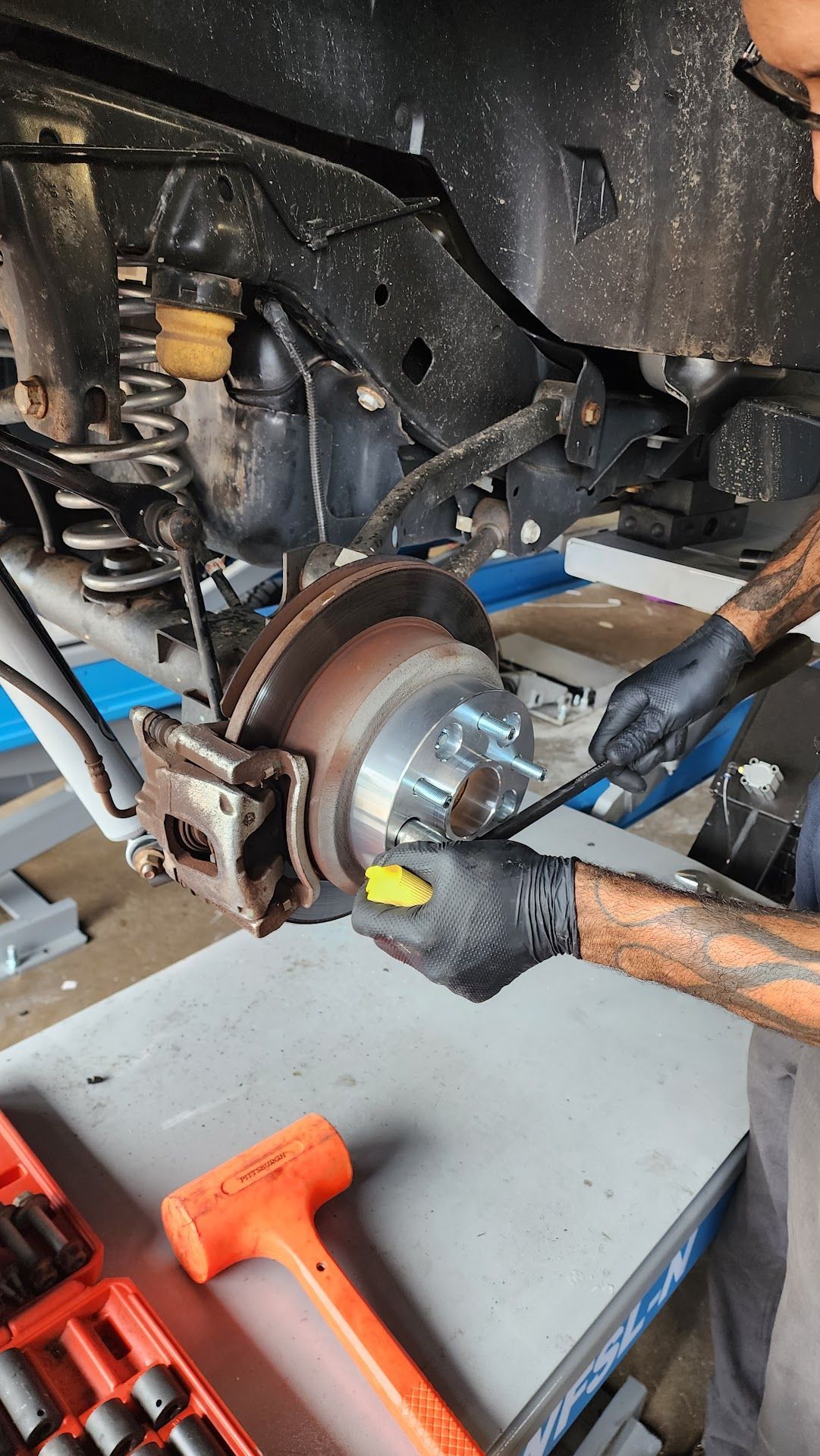 Person Working on the Rear Brake | Tire Tech