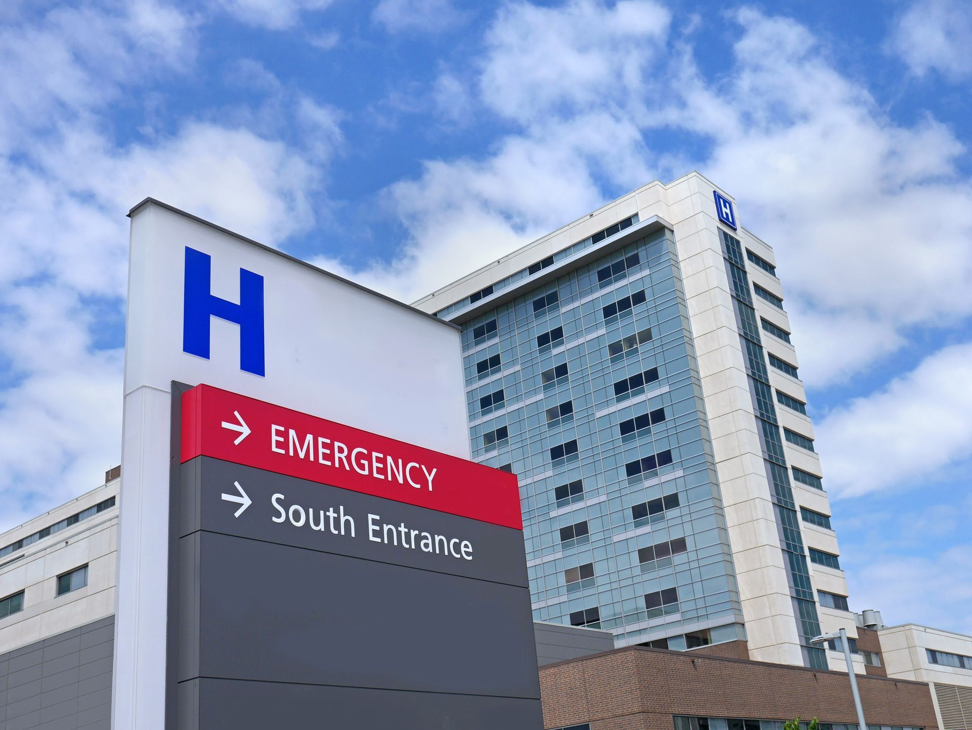 A hospital with an emergency sign in front of it