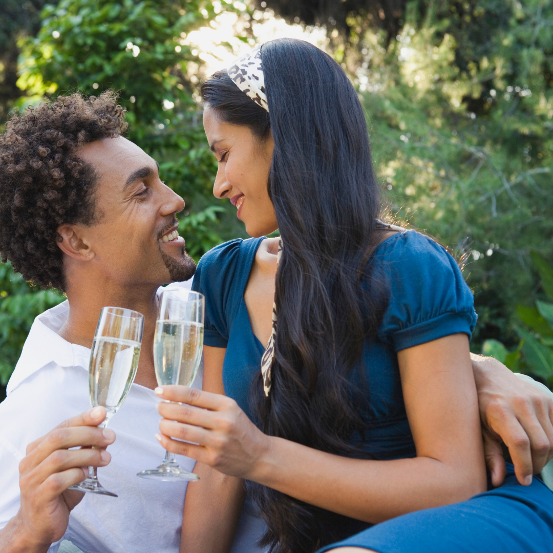 A man and a woman toasting with champagne glasses in Blue Ridge Mountains North Carolina Asheville