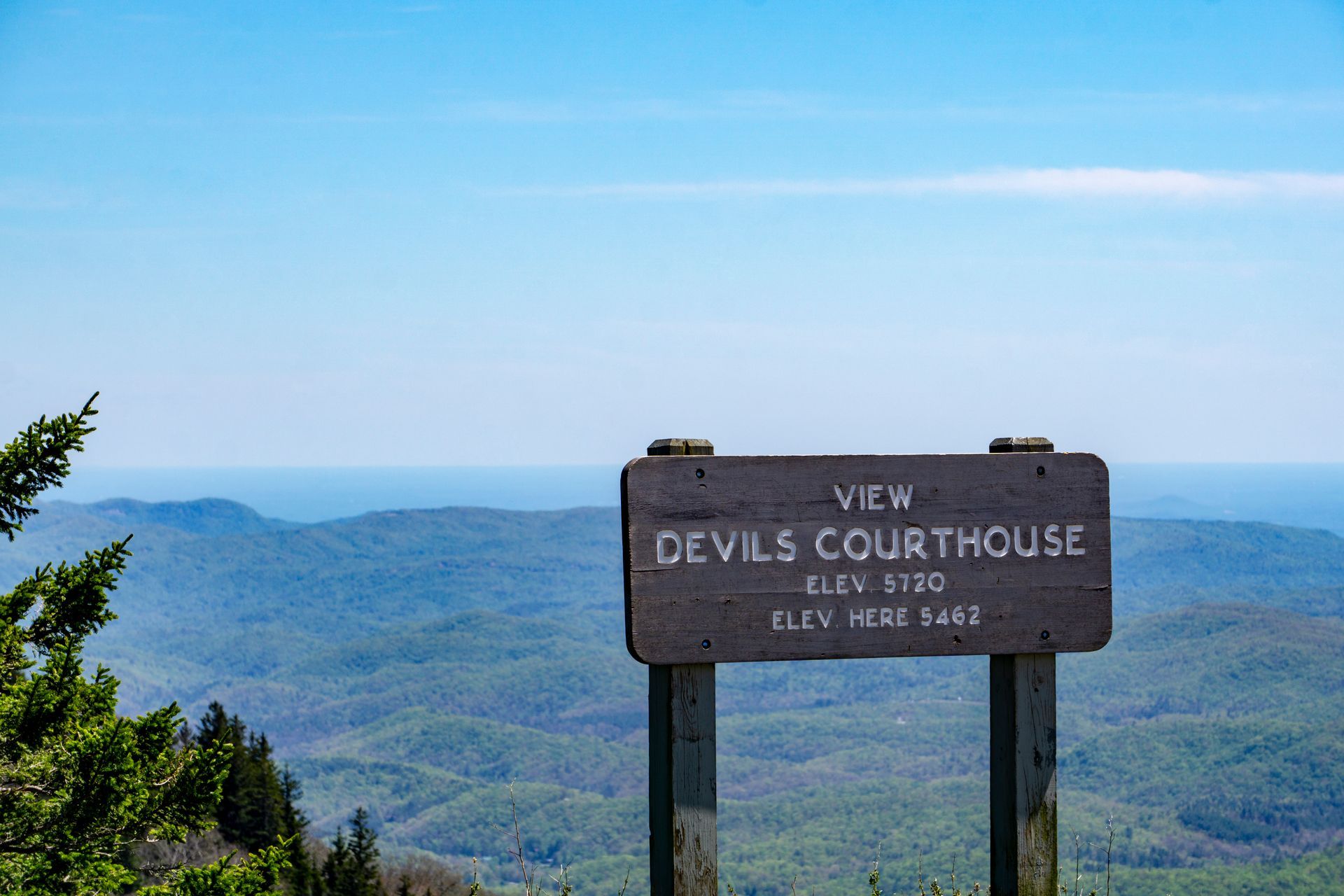 A wooden sign says view devils courthouse elev 5720 elev here 5462