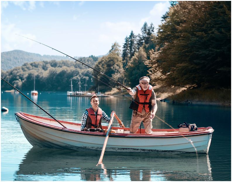 Two men are fishing in a boat on a lake.