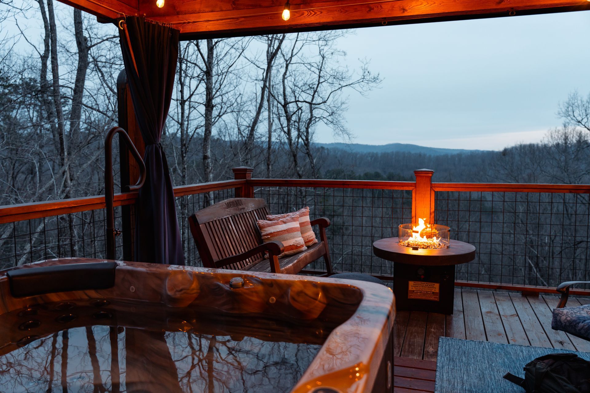 A man and a woman are sitting in a hot tub holding wine glasses.