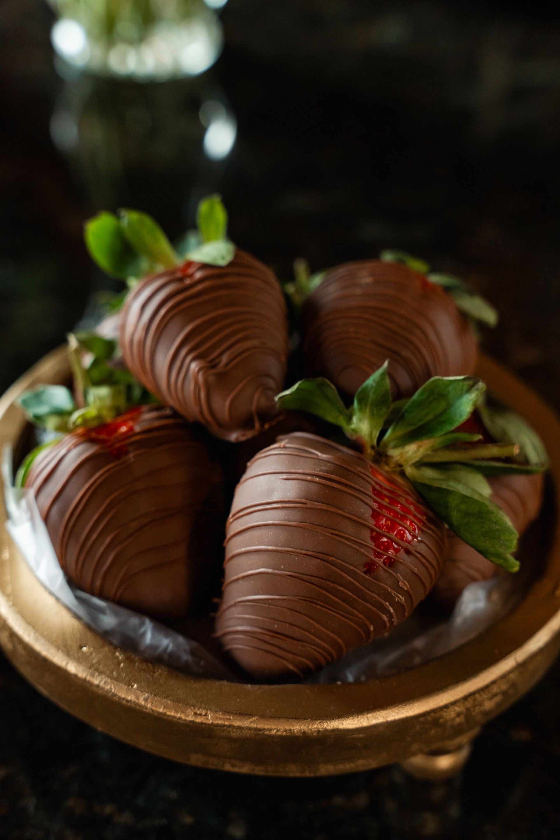 A bunch of chocolate covered strawberries in wrappers