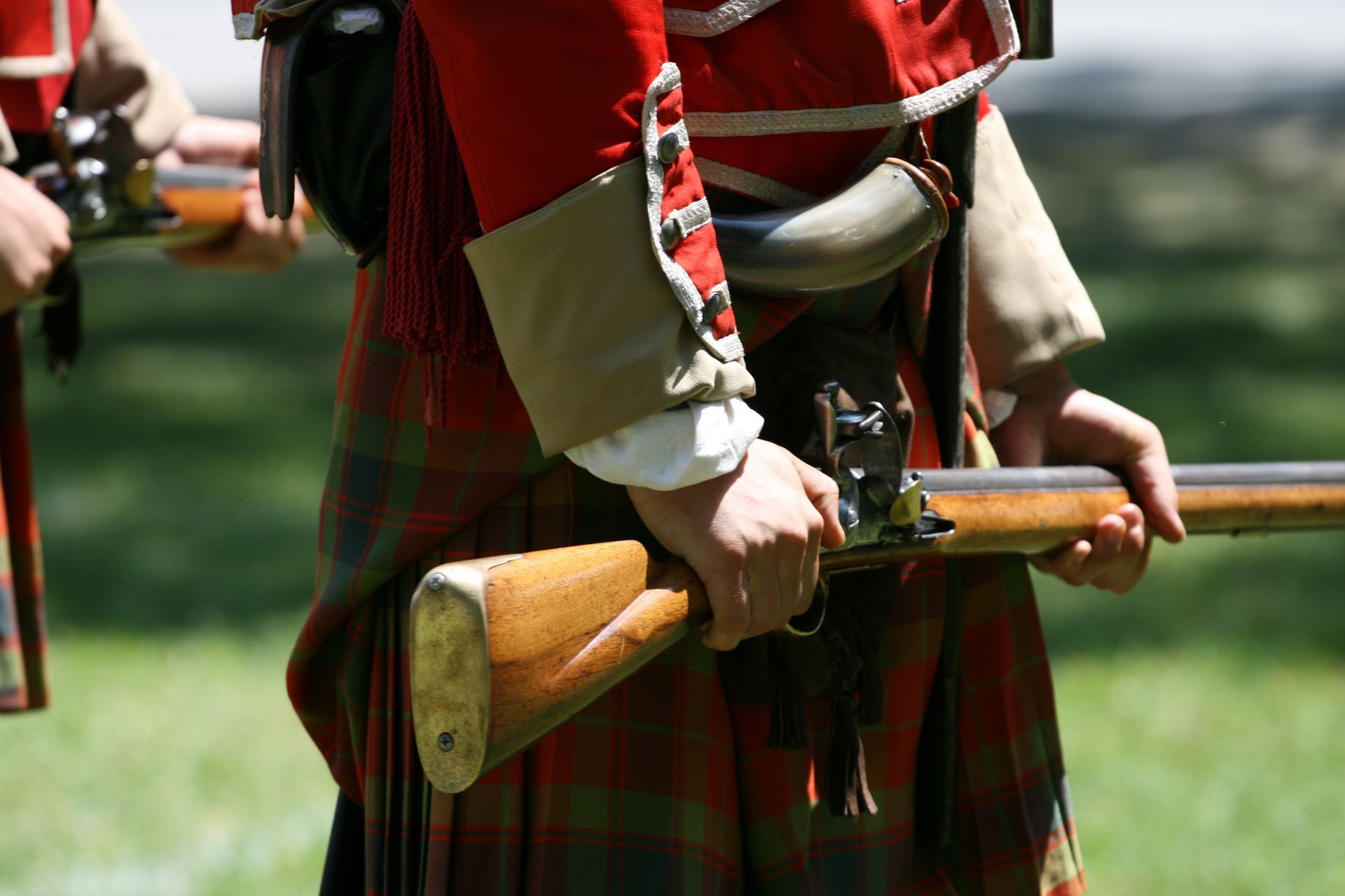 a civil war era soldier holding a gun and re-enacting the war