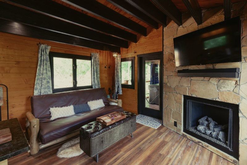 A living room with a couch , fireplace and television.