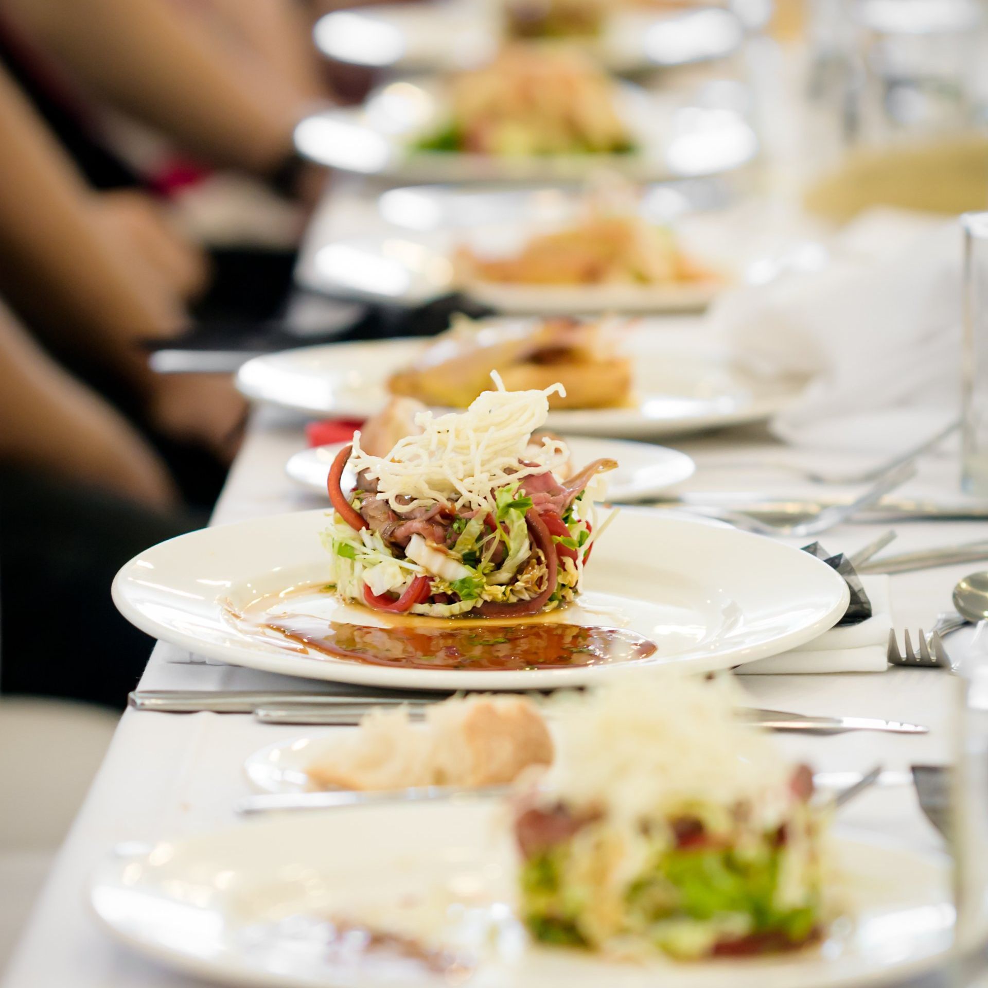 a row of plates of food are lined up on a table