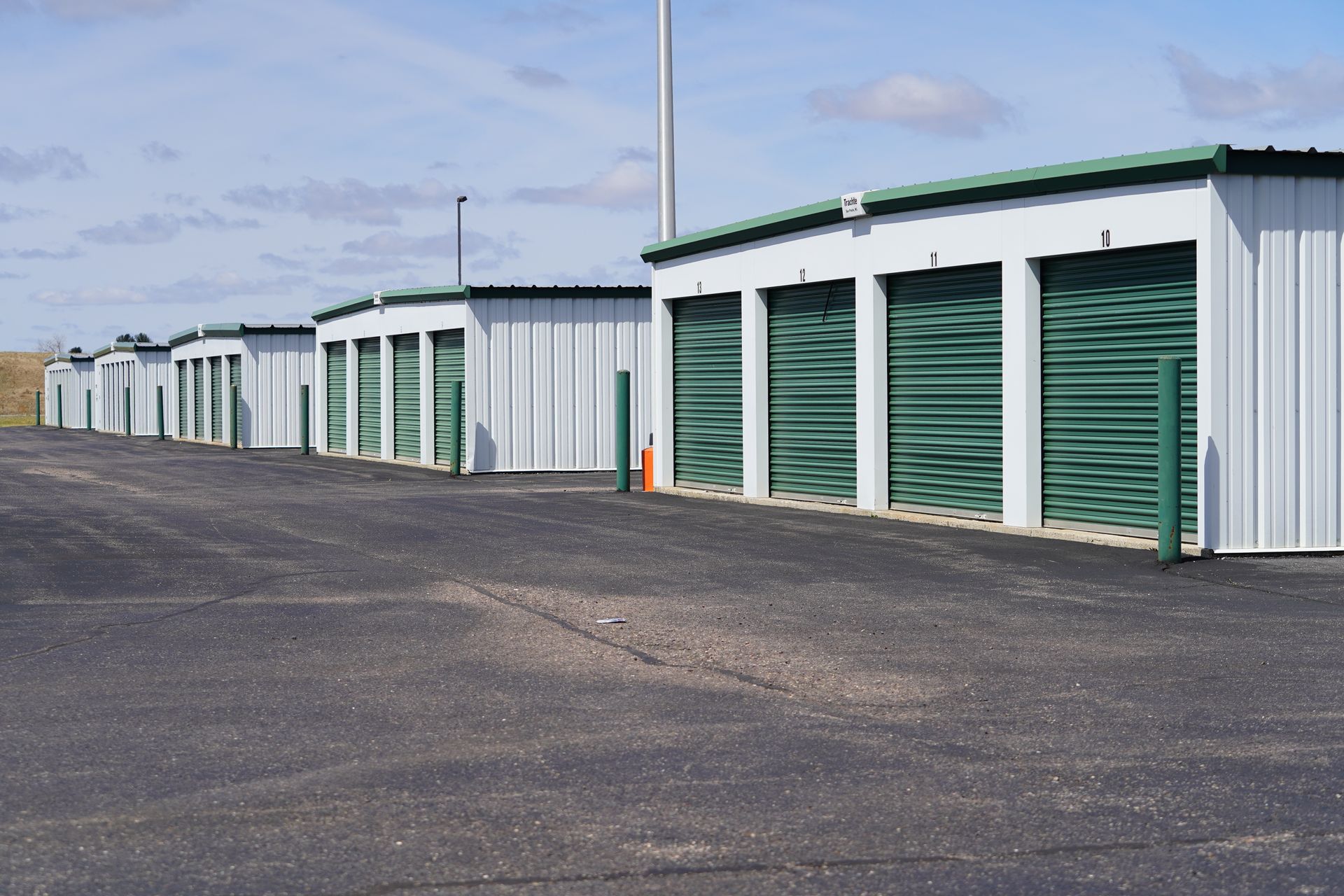 Storage units with red doors, one open showing furniture and items.