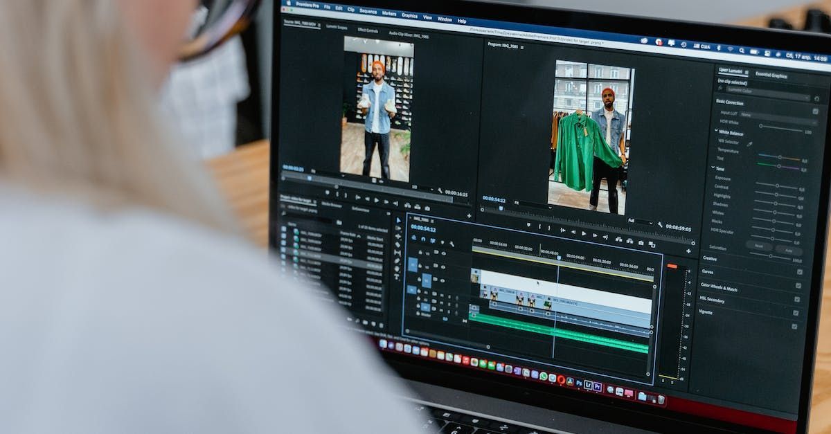 A woman is using a laptop computer to edit a video.