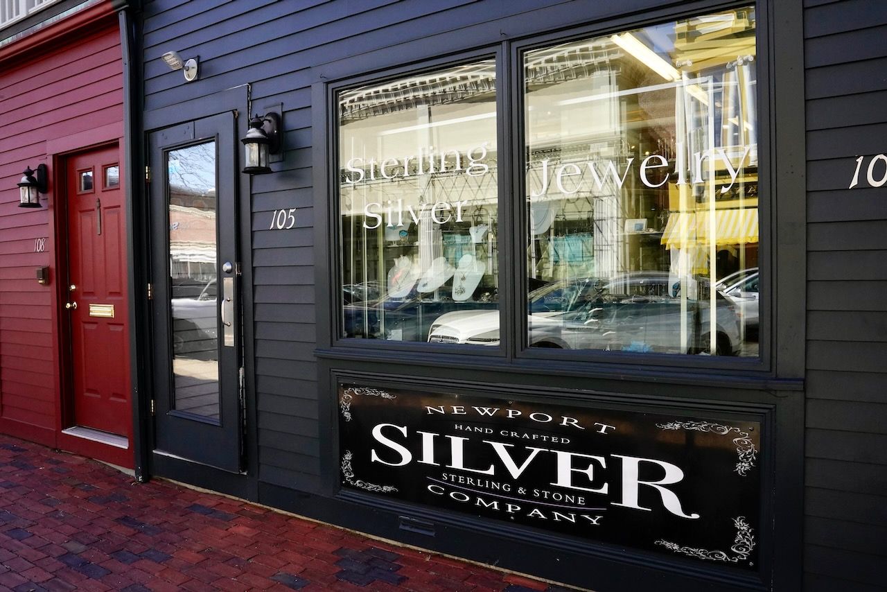 A black building with a red door and a sign that says silver on it.