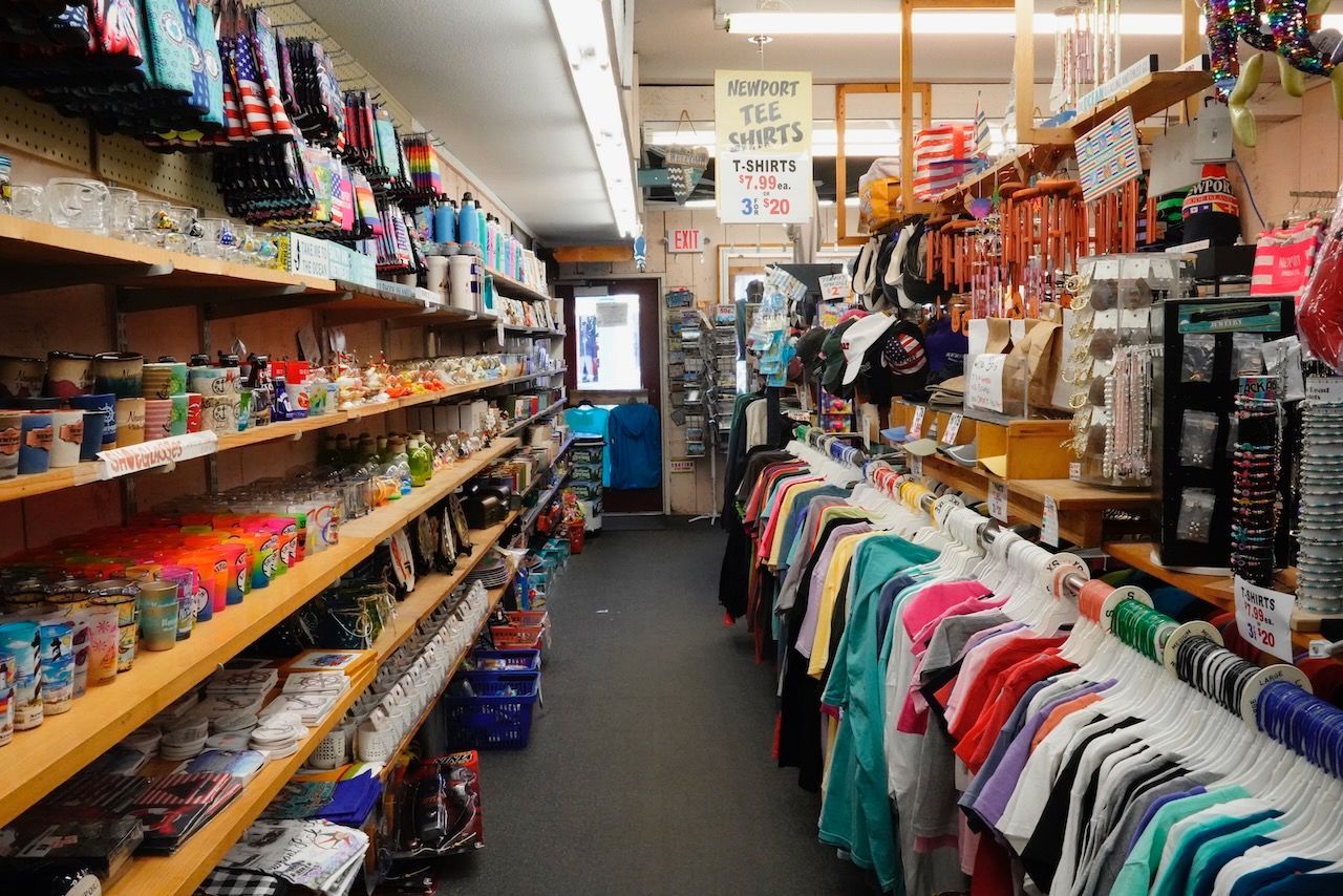 A store filled with lots of shelves and clothes hanging on racks.