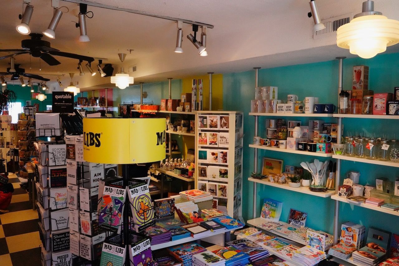 A store filled with lots of items including a lamp that says nbs